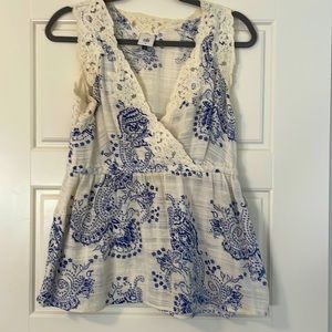 CAbi cream and blue sleeveless blouse